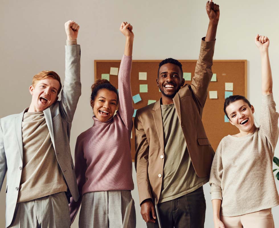 A group of people raising their arms and cheering