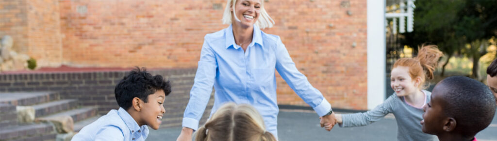 A teacher plays ring around the rosie with her students